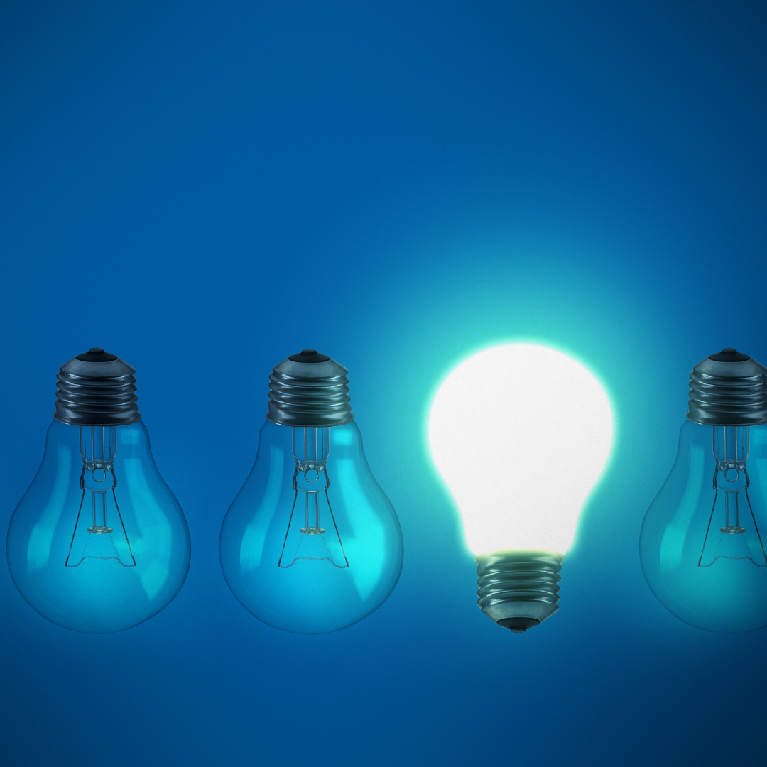 four light bulbs in black and white one of them is in colour